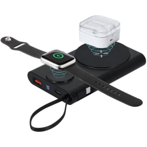A black power bank with a wireless charging pad, featuring a smartwatch and AirPods on top, plus USB ports.