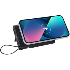 A black power bank with a phone resting on top, displaying a charging icon, featuring a built-in logo.