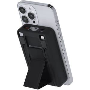 A black power bank attached to a mobile phone, featuring a built-in stand and a logo on the device.