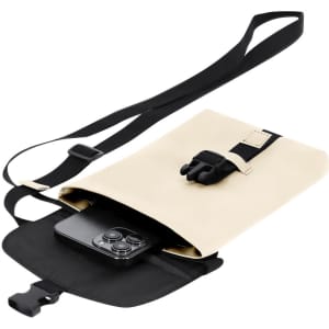 A cream and black shoulder bag with a strap, featuring a phone tucked inside. It has a clasp closure and a branding logo.