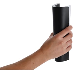 A black notepad held in a hand, featuring a sleek design with a contrasting white edge and a logo.