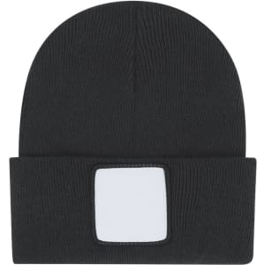 A black beanie featuring a rectangular patch for branding. The knitted fabric provides a snug fit.