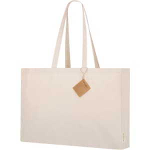 A cream-coloured tote bag with long handles and a tag attached, featuring branding.