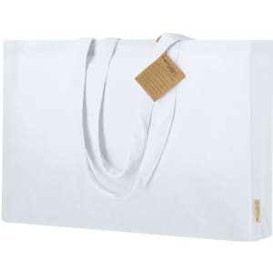 A white tote bag with long handles and a branded tag attached. The bag has a simple, minimalist design.