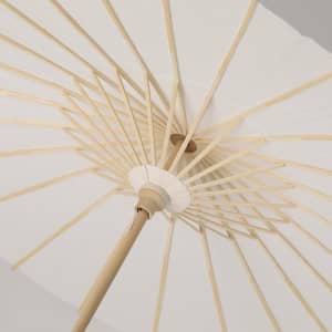 A beige umbrella viewed from underneath, showcasing its wooden frame and structure. It features a logo.