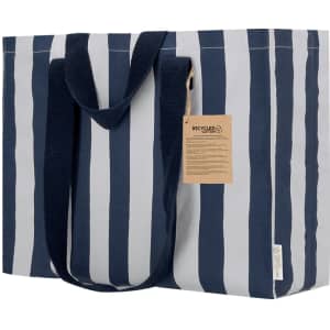A tote bag featuring horizontal navy and light grey stripes, with sturdy handles and a tag.