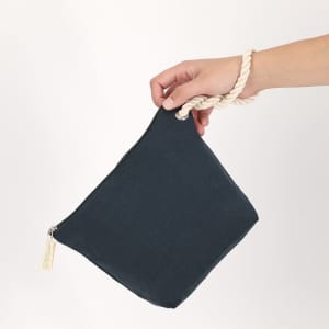 A navy toiletry bag with a rope handle, featuring a zip closure and a small logo.