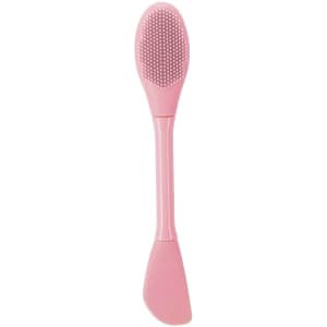 A pink facial spatula featuring a textured side and a smooth side, designed for beauty applications.