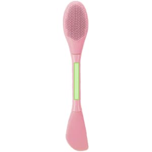 A pink facial spatula with a textured end and a smooth end, featuring a small green section.