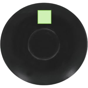 A black saucer with a circular indentation and a small green square. The saucer has a smooth finish.