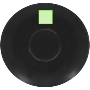 A black saucer with a circular indentation in the centre and a small green square on top.
