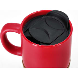 A red travel mug with a black lid inside, designed for drinkware convenience.