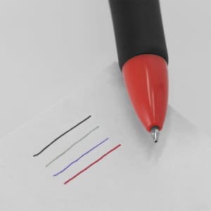 A multicoloured pen with a black body and red tip, writing in black, grey, blue, and red ink on paper.