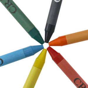 A set of crayon tips in various colours: green, blue, yellow, orange, red, and black, arranged in a circular pattern.