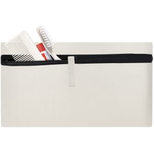 A cream toiletry bag featuring a black zipper, with a comb and toothbrush visible inside.