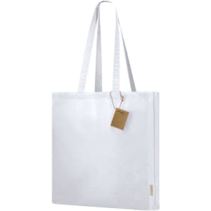 A white tote bag with two handles and a tag. The bag features a simple design and a plain surface.