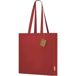 A red tote bag with two handles and a tag, featuring a simple design and a logo.
