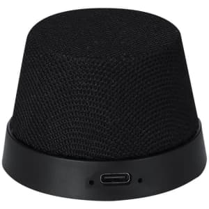 A black Dinarix speaker with a textured fabric exterior and a circular base, featuring a USB-C port.