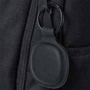 A black tracking device attached to a zippered bag, featuring a circular design and a keyring.