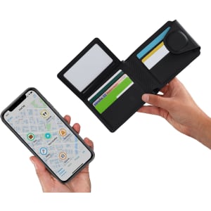 A black tracker card holder wallet is displayed open, revealing card slots and a hand holding a smartphone with a map.