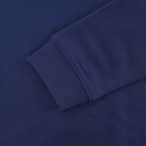 A navy blue sweatshirt sleeve with a smooth texture and ribbed cuff, featuring a logo.