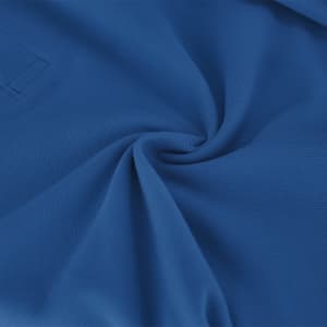 A close-up of a blue polo shirt fabric, showcasing its smooth texture and woven pattern. The shirt has a logo.
