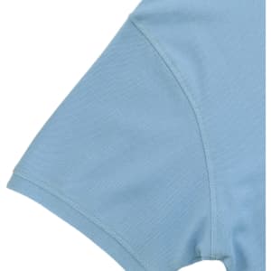 A light blue polo shirt with a short sleeve design and a logo on the fabric.