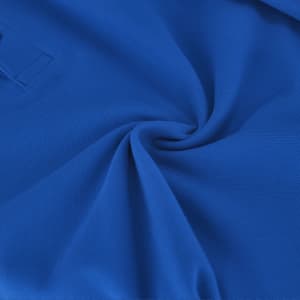A bright blue Tecnic Plus Kids Polo Shirt made from textured fabric, featuring a logo.