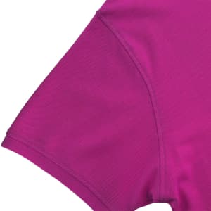 A close-up of a magenta women's polo shirt, featuring a short sleeve and a smooth fabric texture.