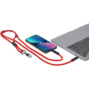 A red charging cable connects a smartphone to a laptop, with a stylish holder included. The image features a logo.