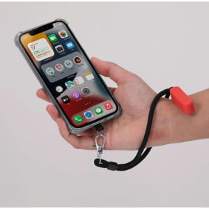 A hand holds a phone in a clear case attached to a black cord with a red holder, featuring a logo.