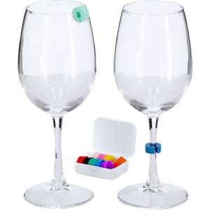 Two clear wine glasses with glass identifiers in assorted colours, next to a small case containing more identifiers.