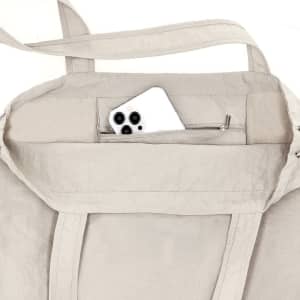 A light beige drawstring bag with a zipped interior pocket containing a white smartphone. There is also a handle visible.