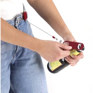 A drink bottle opener in red attached to a belt, being used to open a bottle. The image includes a logo.