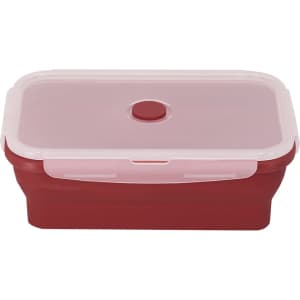 A red lunch box with a pink lid and a button closure, featuring a smooth surface and a rectangular shape.