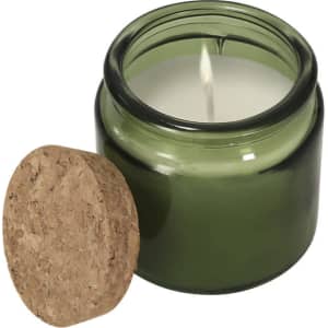 An aromatic candle in a green glass jar with a cork lid, featuring a single wick and a stylish design.