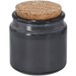 A black jar candle with a cork lid, suitable for home décor and living. It features a smooth, glossy finish.