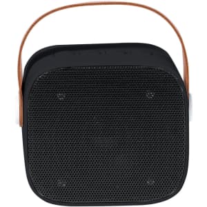 A black portable speaker with a textured grille and a brown leather handle. It features a minimalist design and has a logo.