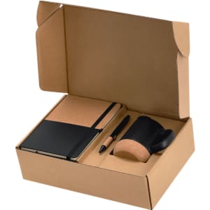 A gift set containing a black notebook, cork-covered mug, pen, and organised packaging.