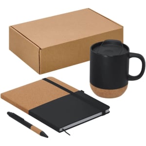A black mug with a cork base, a cork-covered notebook, and a black pen, all in a brown box.