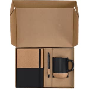 A gift set featuring a black mug, cork notebook, and black pen, packaged in a cardboard box.