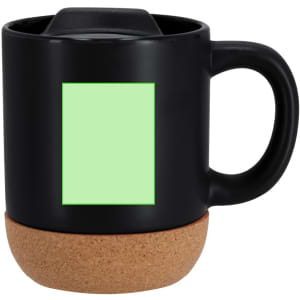 A black mug with a cork base and a blank green label area for branding or personalisation.