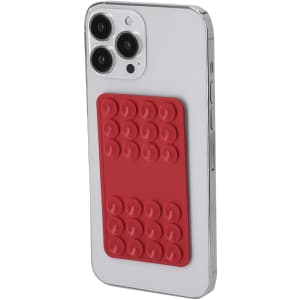 A smartphone with a red silicone phone holder attached to its back, featuring a textured grip.