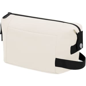 A cream toiletry bag with a black zipper, strap, and a logo on the side.