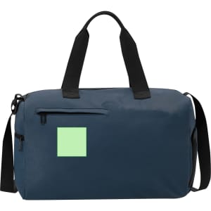 A navy duffle bag with black handles and a green square on the front, featuring a zippered pocket.