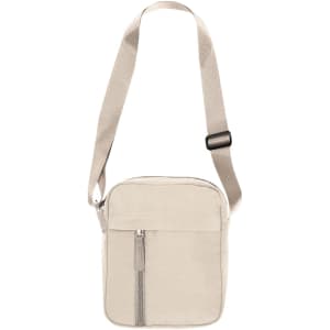 A beige shoulder bag with a zippered front pocket and an adjustable strap. It features a logo on the front.