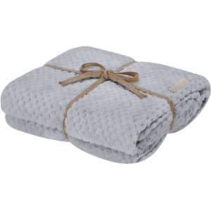 A grey Iridian Blanket neatly folded and tied with a natural twine ribbon, featuring a soft, textured surface.