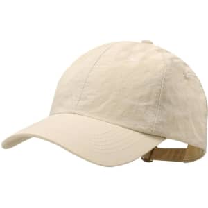 A beige cap with a curved brim, featuring an adjustable strap at the back and a logo on the front.