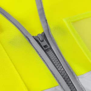 A close-up of a bright yellow reflective vest featuring a grey zipper and stitching details.