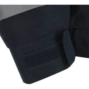 A close-up of the cuff of a Rauric Parka in black and grey, featuring a Velcro fastening and a branding logo.